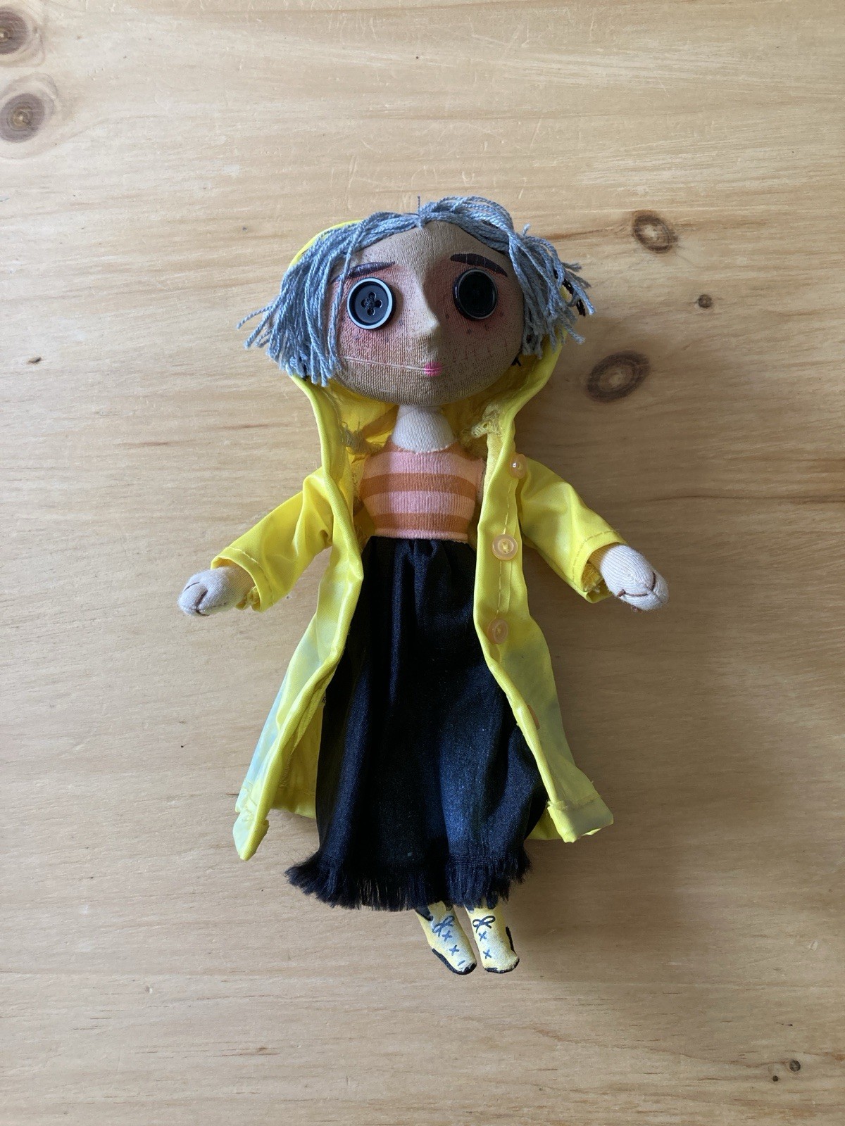NECA Coraline Prop Doll with Yellow Raincoat & Rattle Head