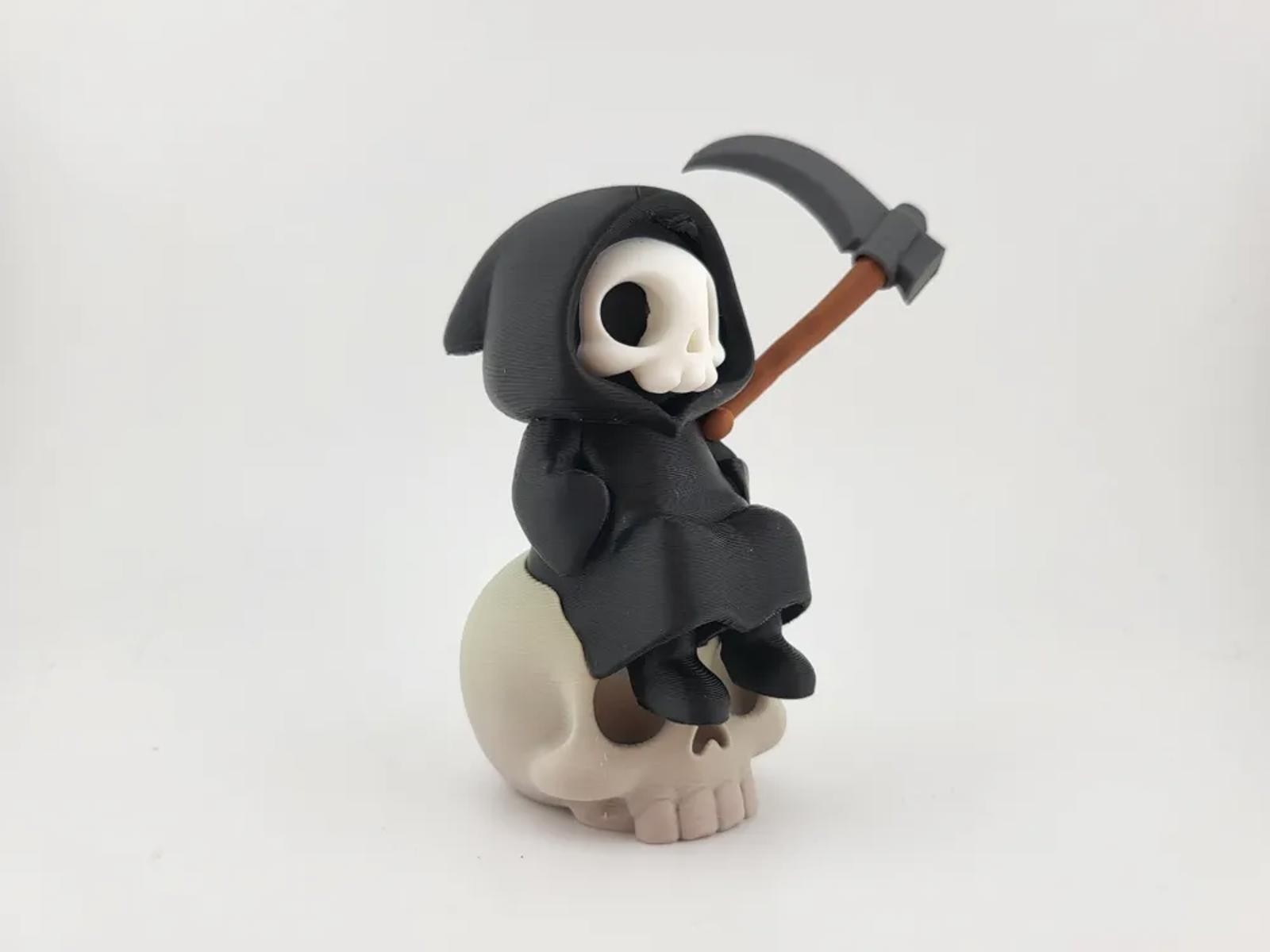 Kawaii Grim Reaper on Skull – Cute Spooky Desktop Decor